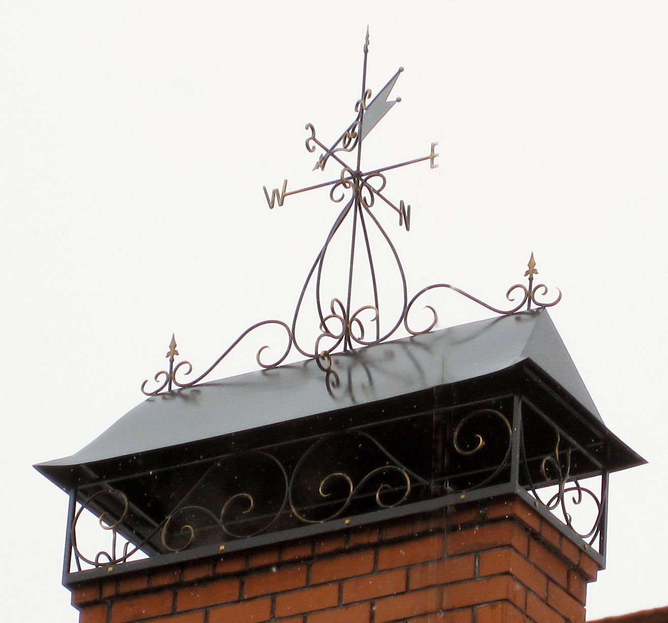 Weather vane mounted on chimney pipe