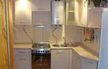 Kitchen design in Khrushchev with a geyser and a refrigerator